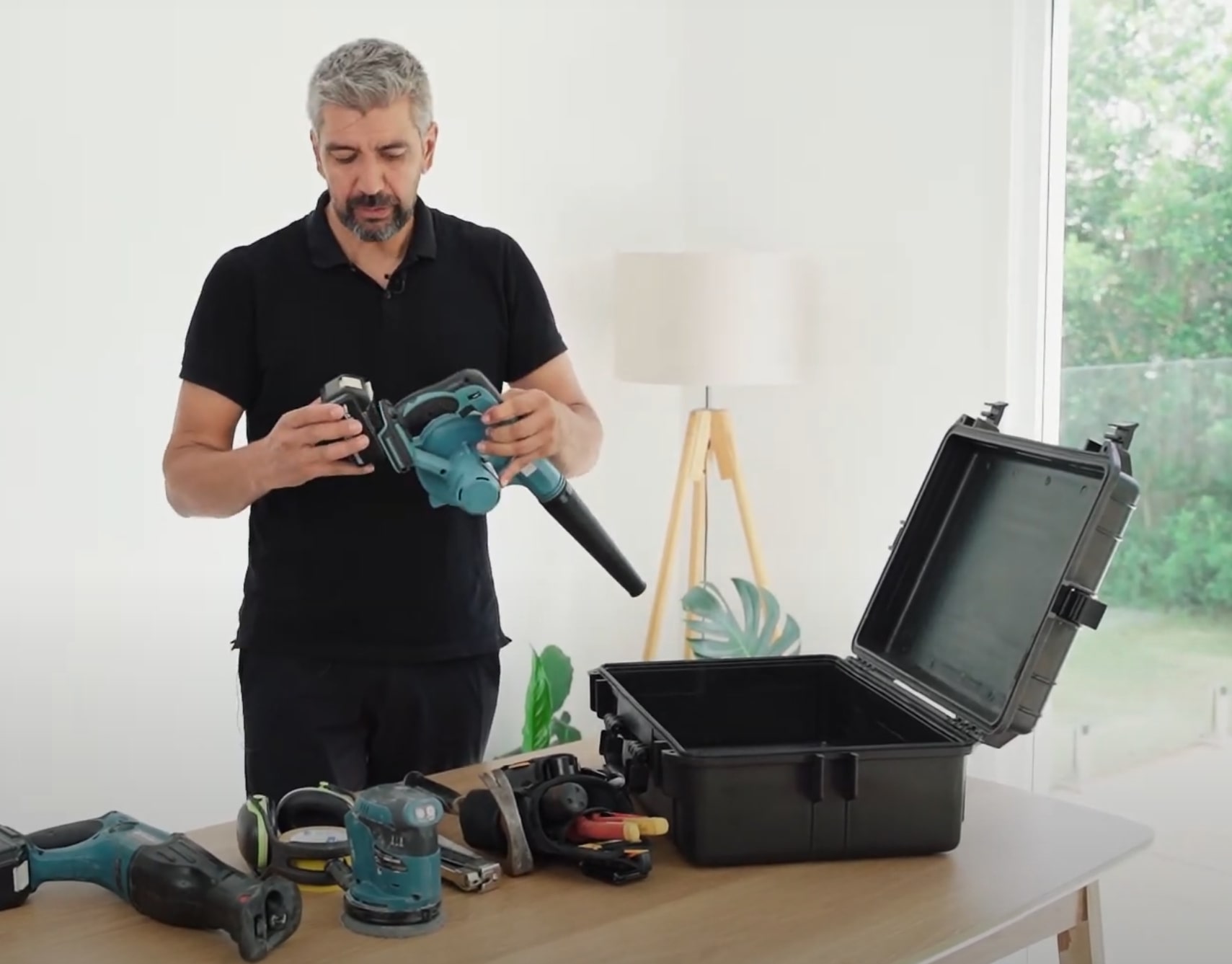 Professional examining water damage restoration equipment and tools